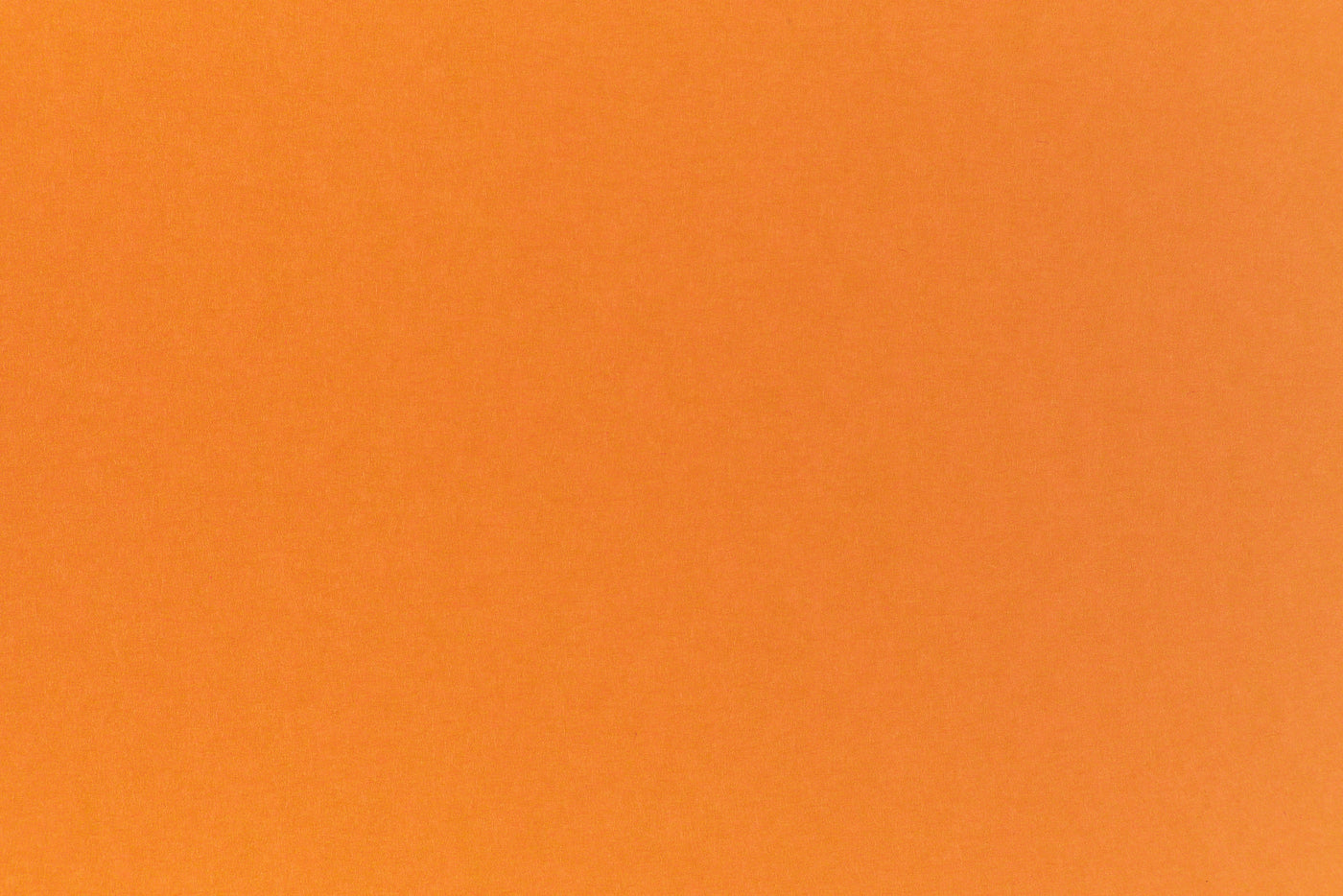 Bright neon orange cardstock paper sample. 