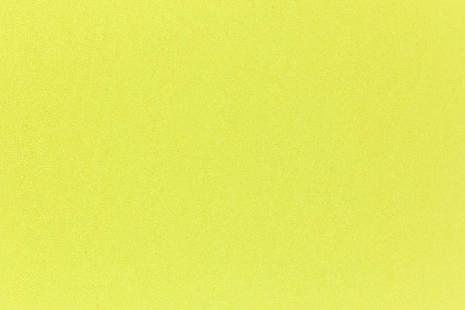 Brilliant neon yellow cardstock paper in close detail.