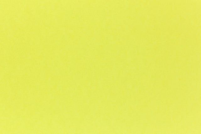 Brilliant neon yellow cardstock paper in close detail.