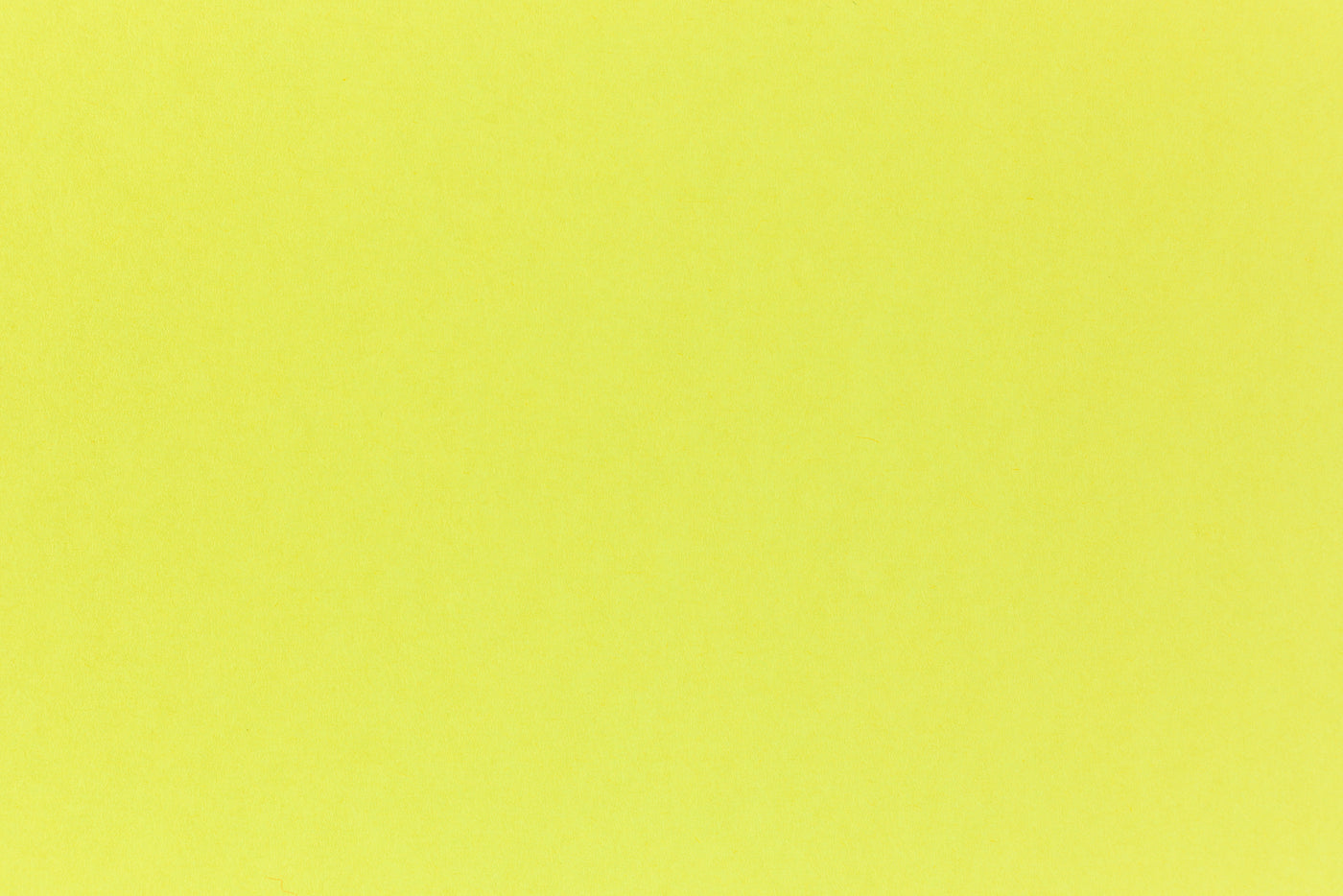 Brilliant neon yellow cardstock paper in close detail. 