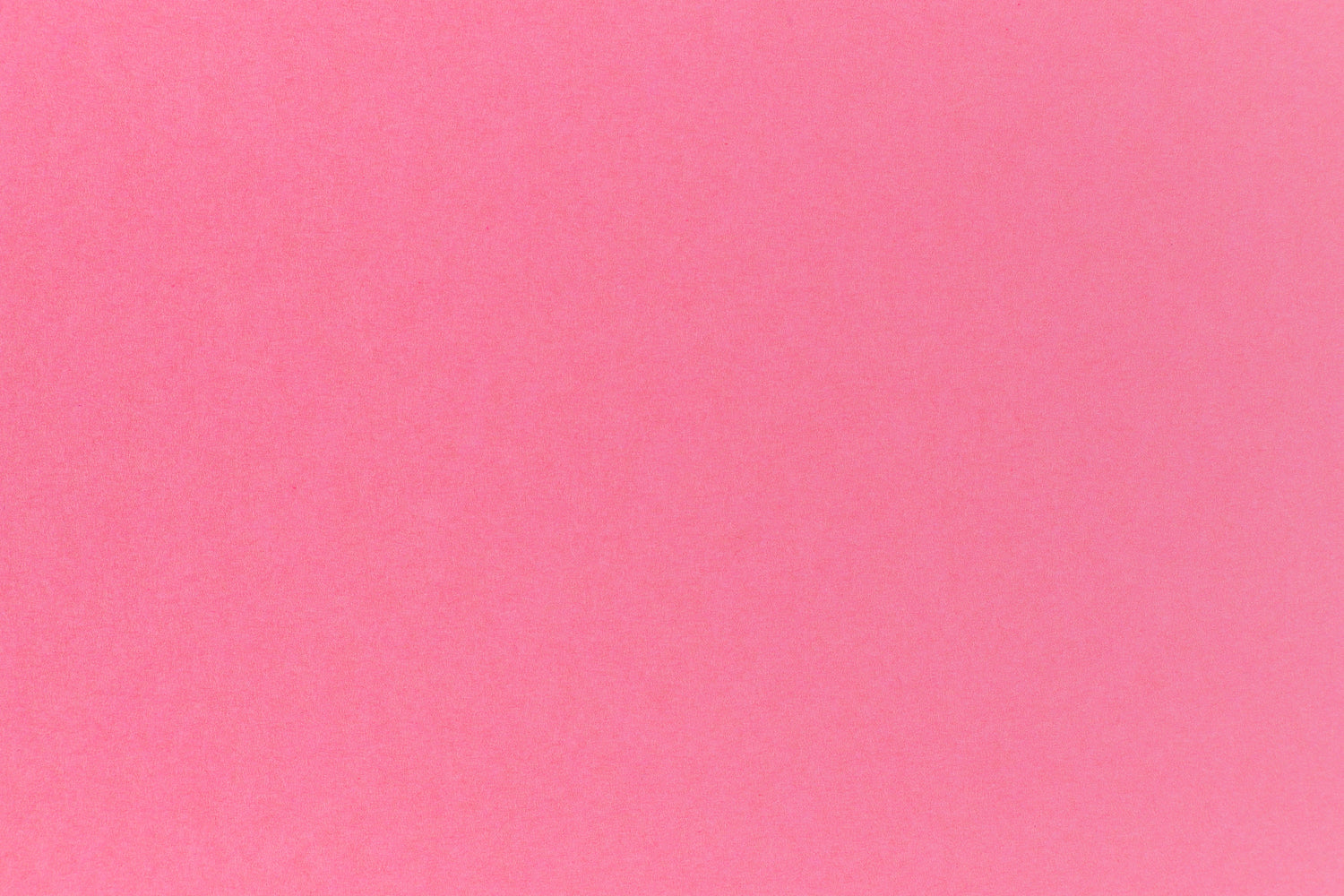 Bright pink crafting paper in close detail.