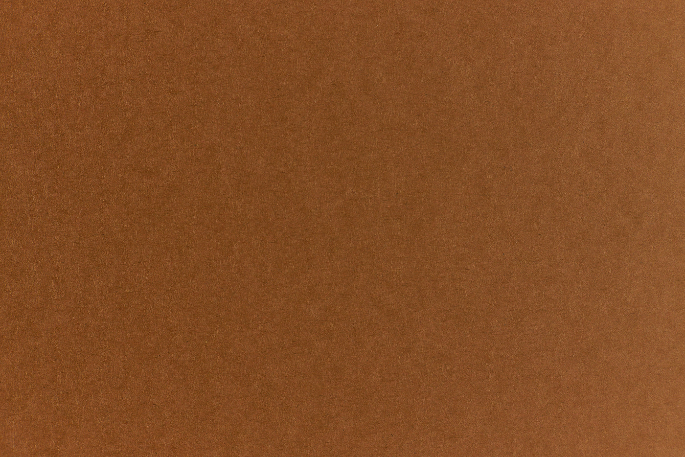 Brown crafting paper with a speckled appearance. 