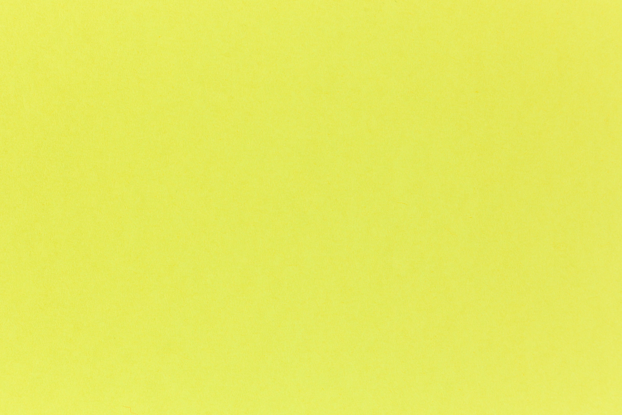 Brilliant neon yellow cardstock paper in close detail. 