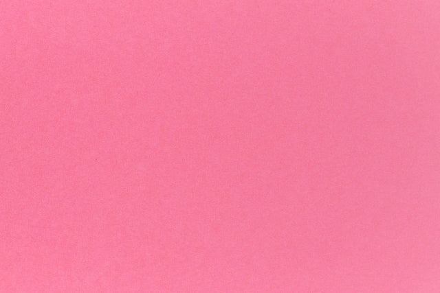 Bright pink crafting paper in close detail.