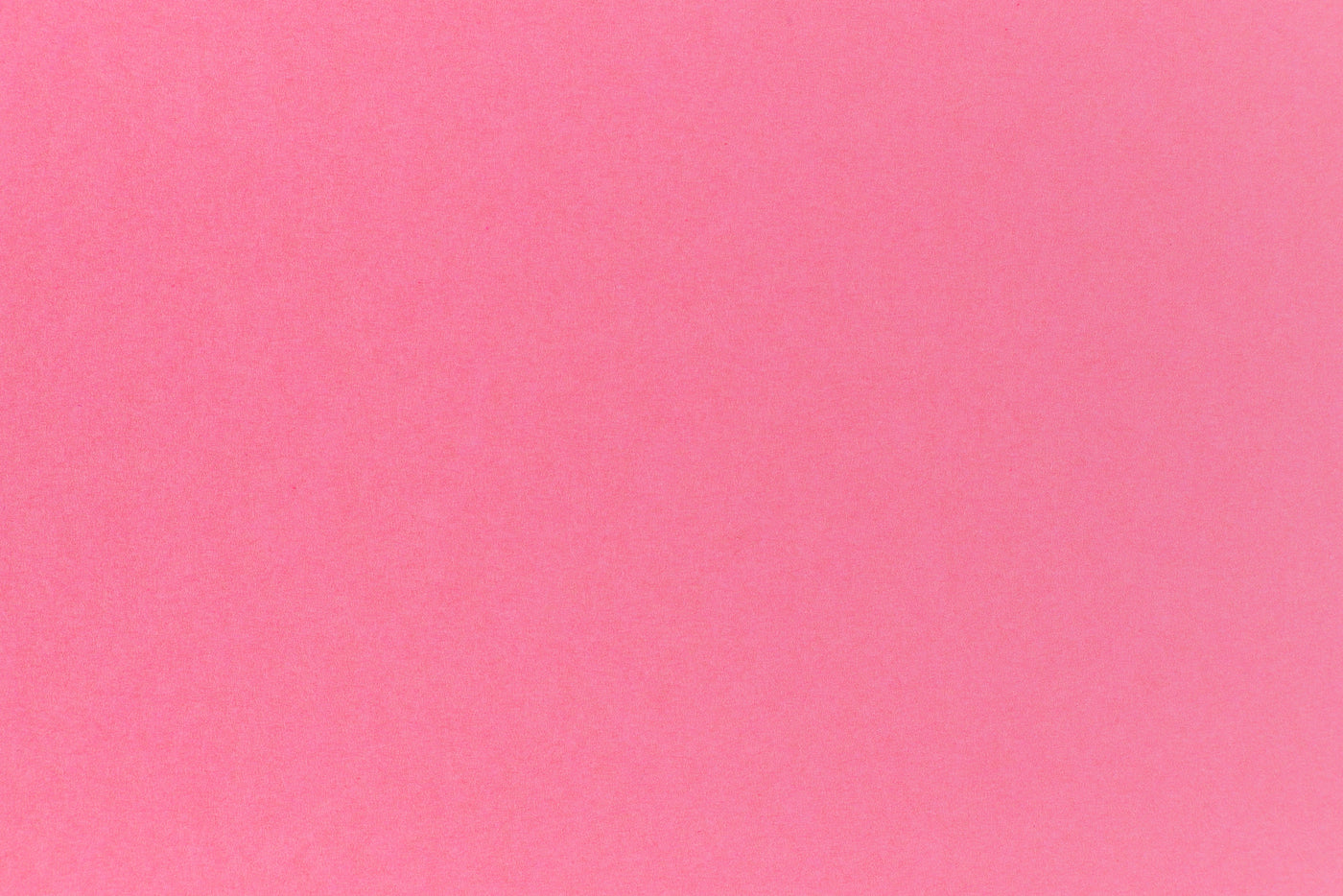 Bright pink crafting paper in close detail.