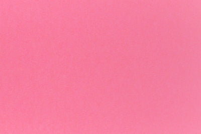 Bright pink crafting paper in close detail.