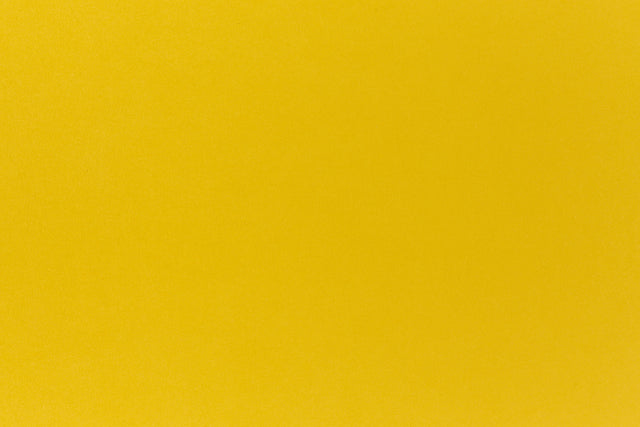 Deep yellow crafting paper shown in close detail. 