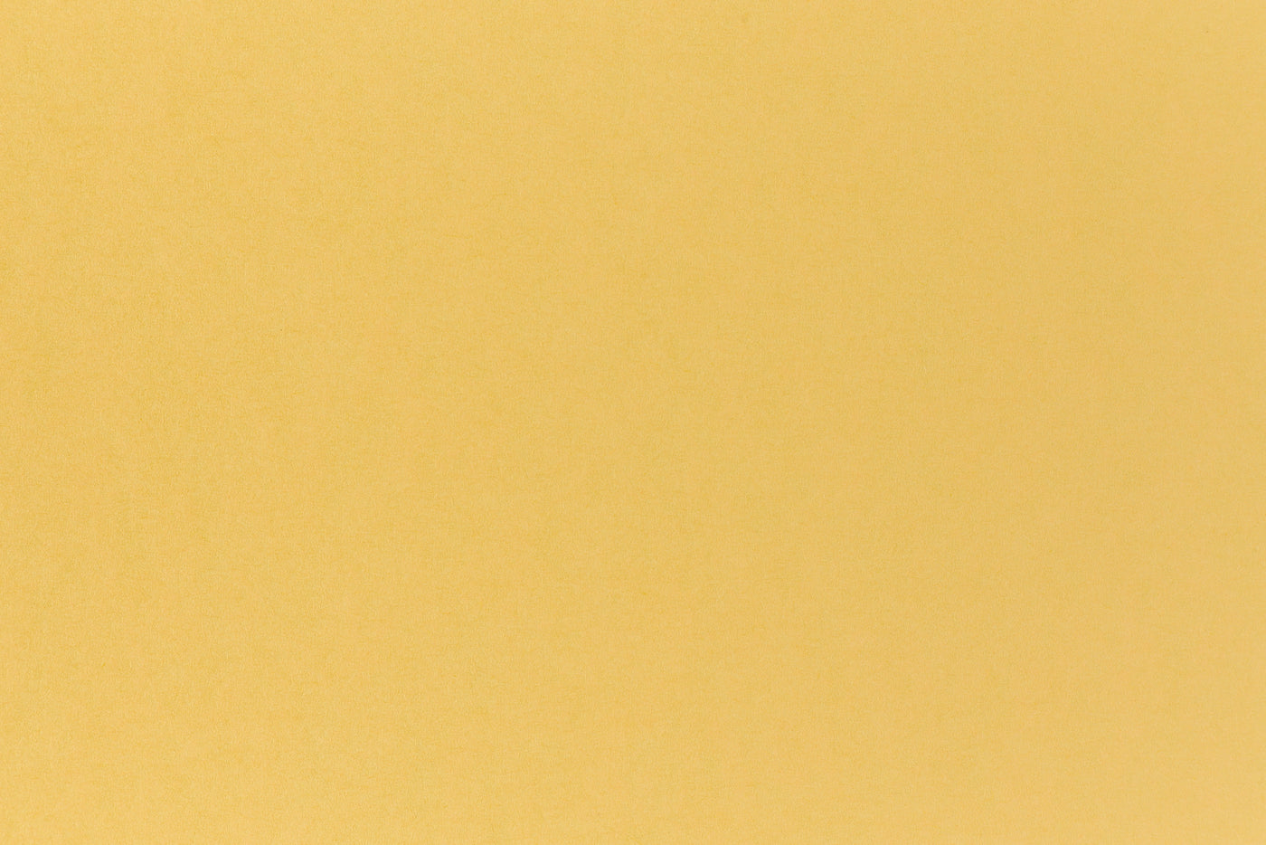 Deep, rich yellow cardstock viewed close up. 