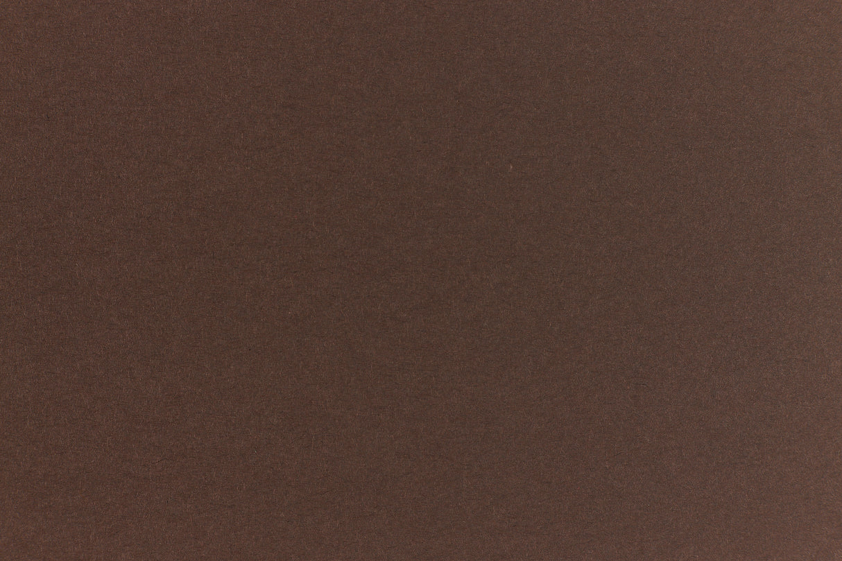 A deep and dark brown-black paper viewed in close detail. 