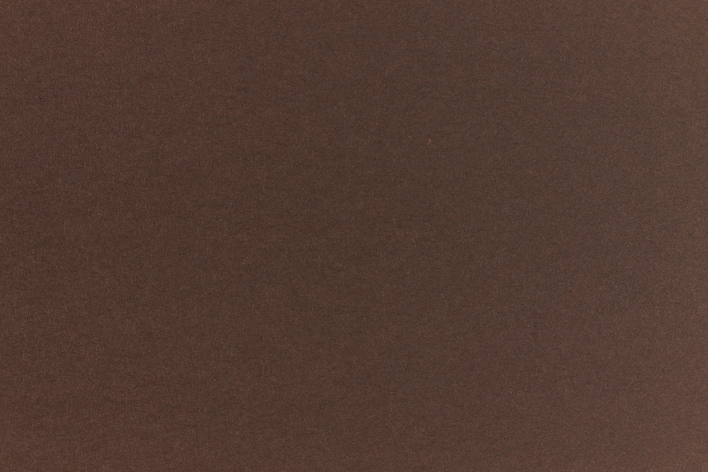 A deep and dark brown-black paper viewed in close detail. 