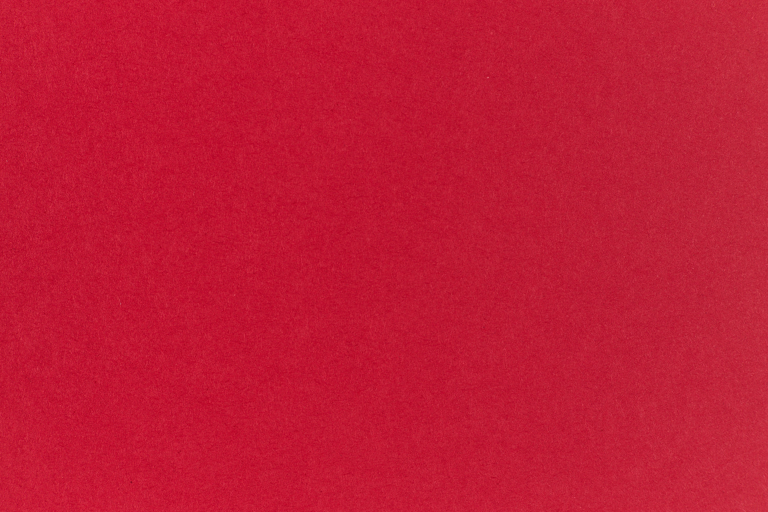 Bright red crafting paper viewed close up. 
