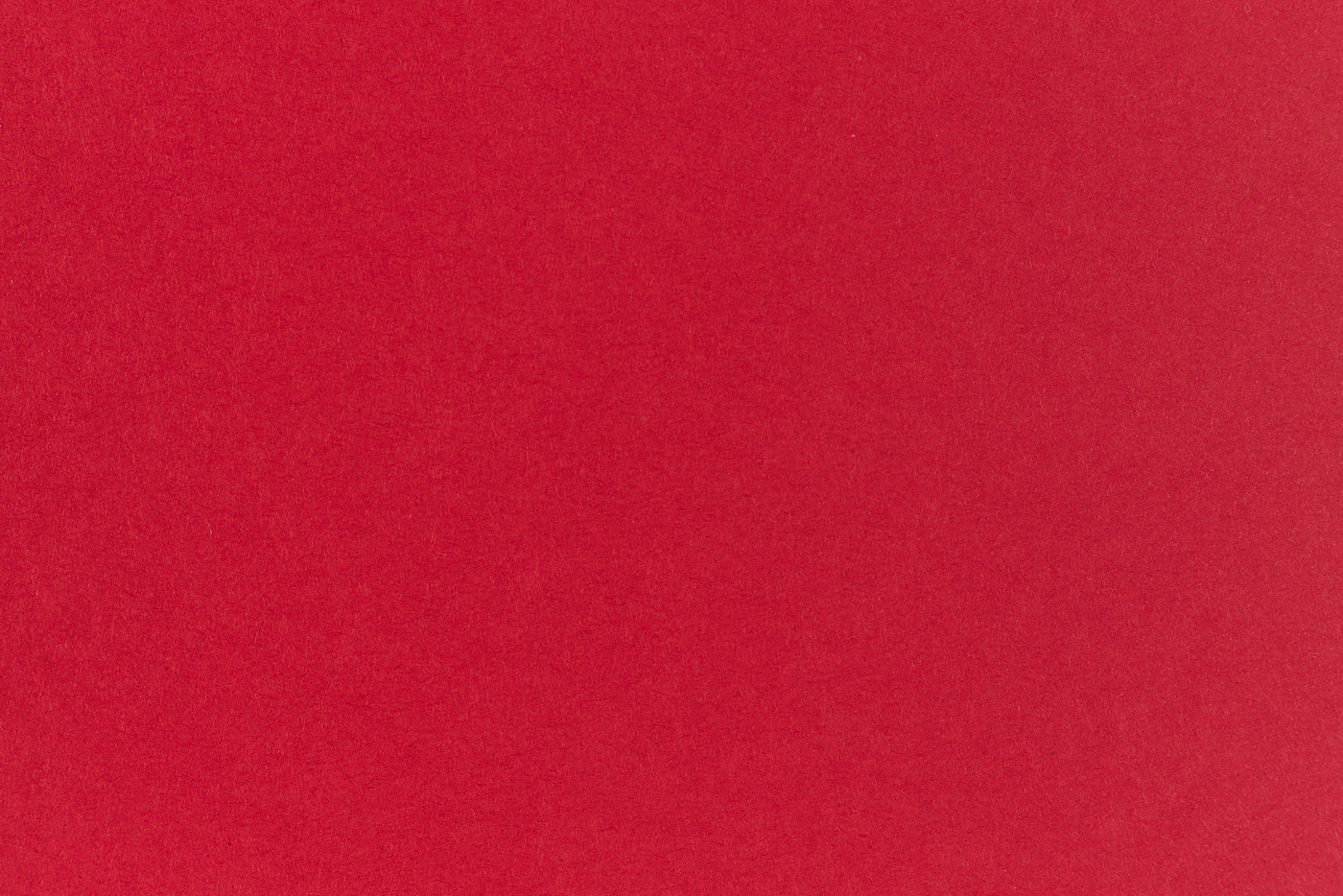 Bright red crafting paper viewed close up. 