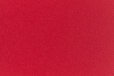 Bright red crafting paper viewed close up. 