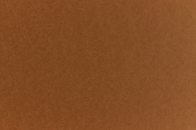 Brown crafting paper with a speckled appearance. 