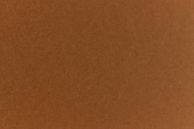 Brown crafting paper with a speckled appearance. 